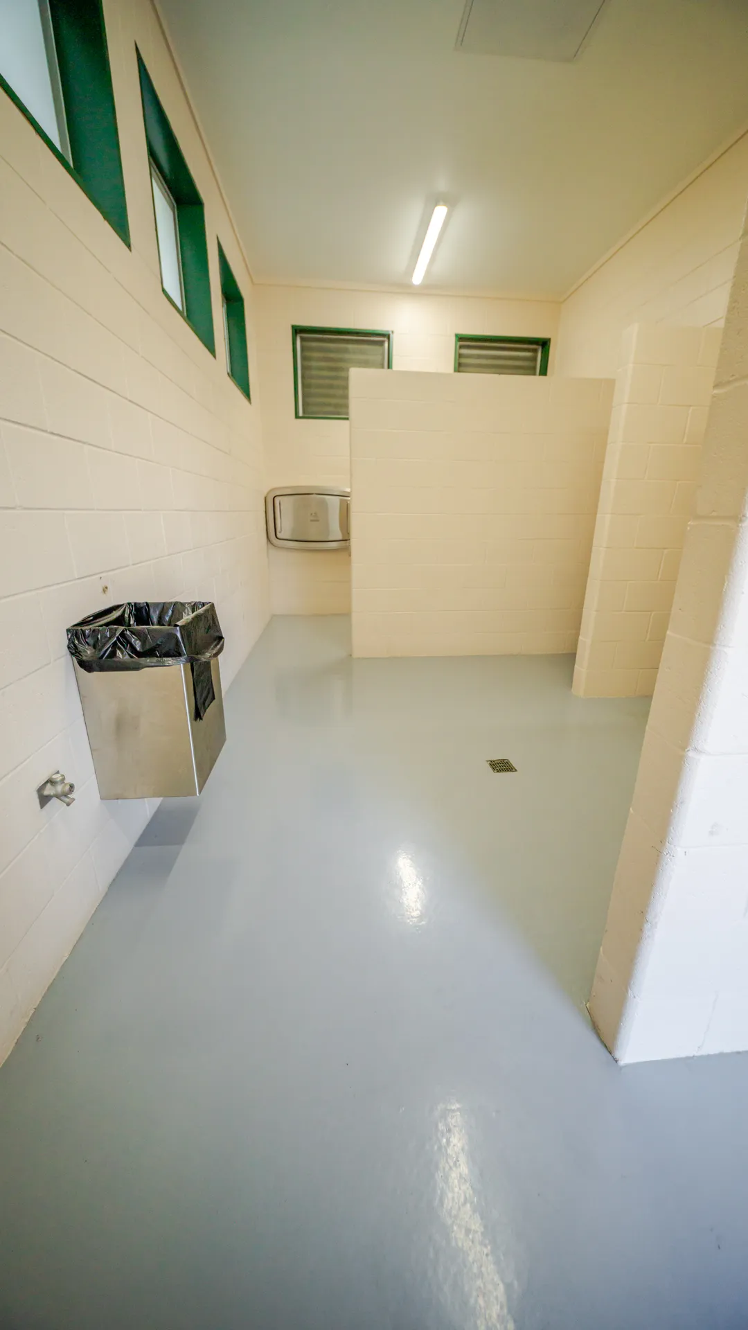 Light gray epoxy floor coating installed in a commercial restroom
